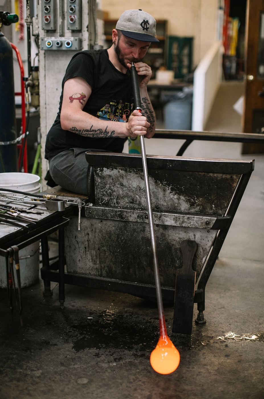 Austin blowing into the pipe at his bench